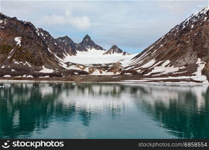 Snowy mountains along the Magdalenafjord in Svalbard islands, Norway. Magdalenafjord in Svalbard islands, Norway
