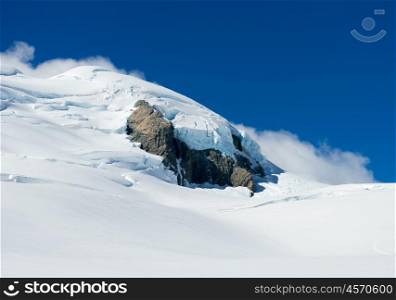 Snowy mountains. Mountain landscape with snow and clear blue sky