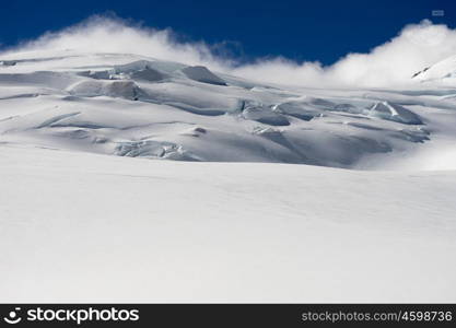 Snowy mountains. Mountain landscape with snow and clear blue sky