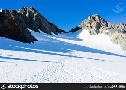 Snowy mountains. Natural mountain landscape with snow and clear blue sky