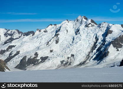 Snowy mountains. Natural mountain landscape with snow and clear blue sky