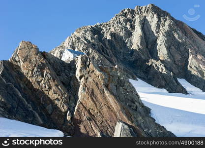 Snowy mountains. Natural mountain landscape with snow and clear blue sky