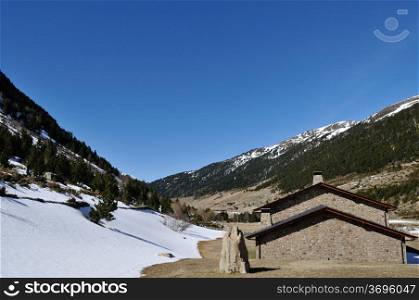 snowy mountains of Andorra la Vella with a house
