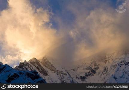 Snowy mountaintops and clouds