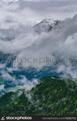 Snowy Peak of Mountain Range in Clouds. Alps in Clouds