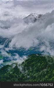 Snowy Peak of Mountain Range in Clouds. Alps in Clouds