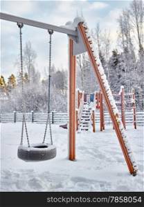 Snowy playground in December, frost and cold weather