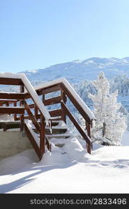Snowy steps to a wooden chalet