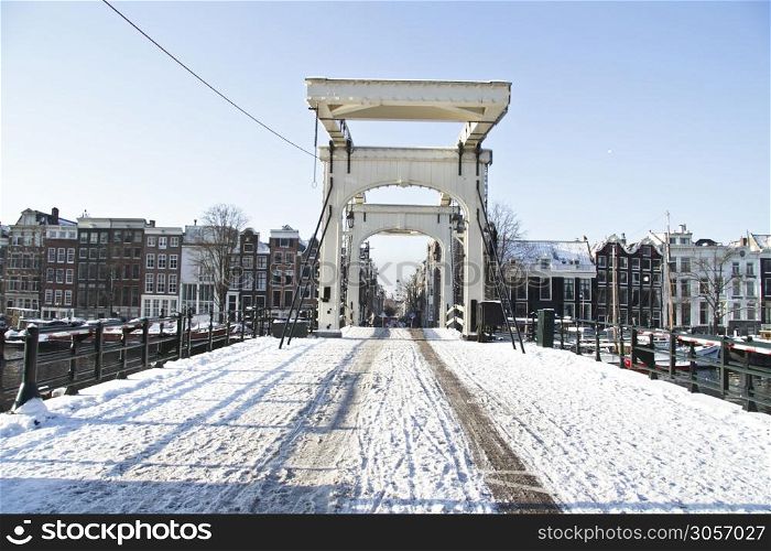 Snowy thiny bridge in Amsterdam the Netherlands in winter