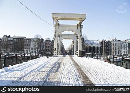 Snowy thiny bridge in Amsterdam the Netherlands in winter