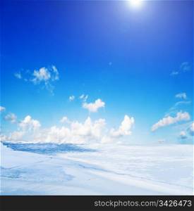 Snowy winter landscape and sunny blue sky
