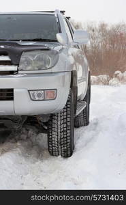 Snowy winter road ahead an unrecognizable car