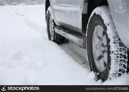 Snowy winter road ahead an unrecognizable car
