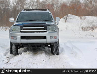 Snowy winter road ahead an unrecognizable car