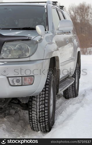 Snowy winter road ahead an unrecognizable car