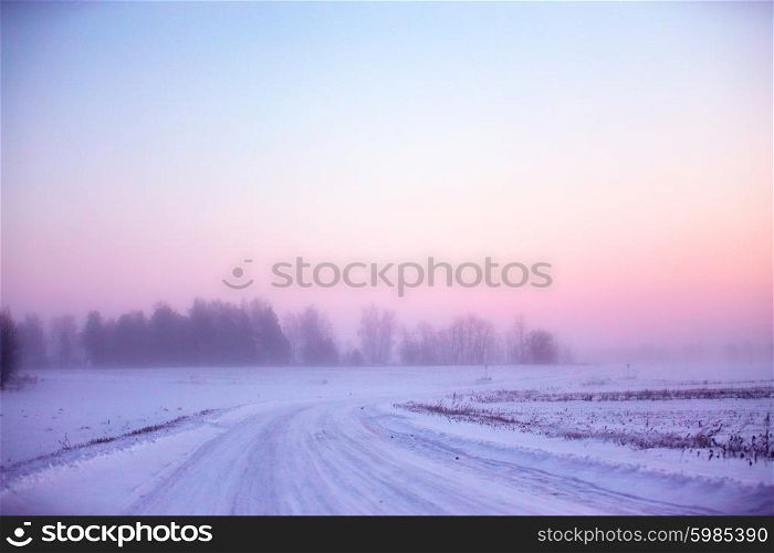 Snowy winter road in Belarus. Winter foggy morning.
