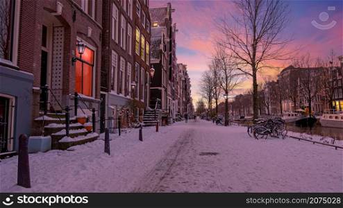 SnowyAmsterdam in the Netherlands in winter at sunset