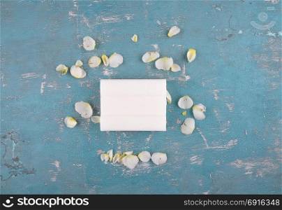 Soap and rose petals on weathered background