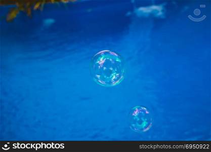 Soap bubbles fly in the swimming pool.