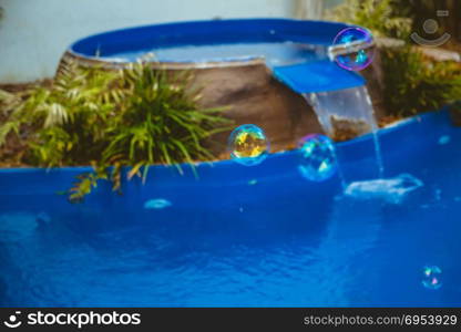 Soap bubbles fly in the swimming pool.