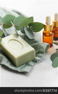 Soap, eucalyptus,  aroma oils,   spa objects on a concrete background.  Skin care, body treatment concept. 