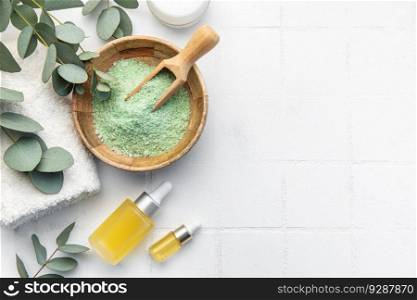 Soap, eucalyptus, towel, massage salt, aroma oil,  spa objects on white tile background. Top view. Skin care, body treatment concept. 