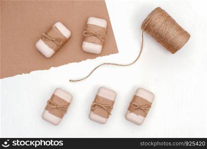 Soap set decorated with craft paper and skein of twine on white background. Organic cosmetics concept. Top view Flat lay Template for design.. Soap set decorated with craft paper and skein of twine on white background. Organic cosmetics concept. Top view Flat lay Template for design