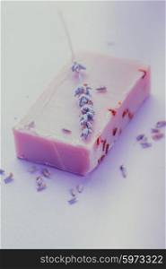 Soap with dry lavender over lilac background. lavender soap