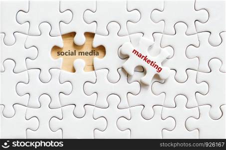 Socail media and marketing words on jigsaw puzzle background, online business concept, digital marketing, e commerce