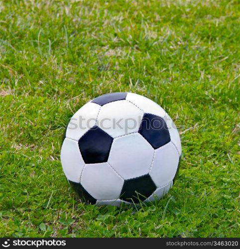 Soccer ball black and white on the grass