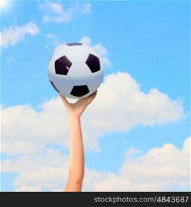 Soccer ball in hand. Close-up image of hand holding soccer ball