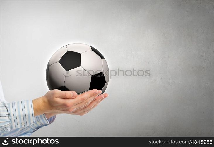 Soccer ball in hands. Close up of businessman holding soccer ball in palms