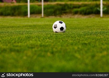 Soccer ball on a green grass close-up. Concept - football passion. Soccer ball on the grass before the game