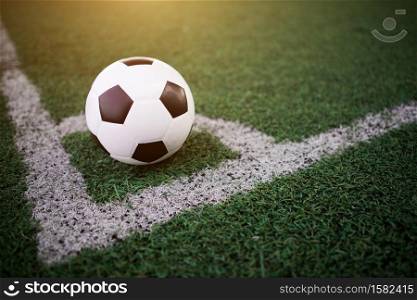 soccer ball on the white line at stadium