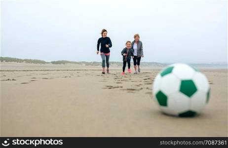 Soccer ball with three people running in the background. Soccer ball with three running people