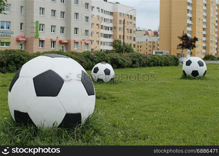 soccer balls on the green lawn