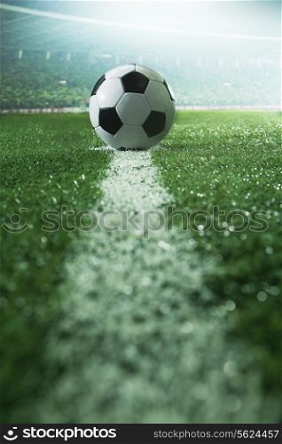 Soccer field with soccer ball and line, side view