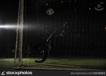 soccer football goal keeper in night with falling rain