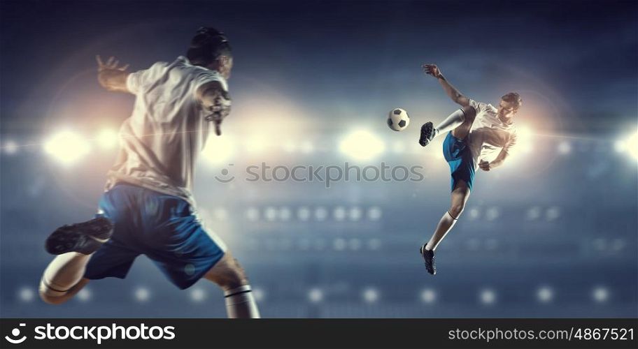 Soccer game in action. Players fight over control of ball during football game