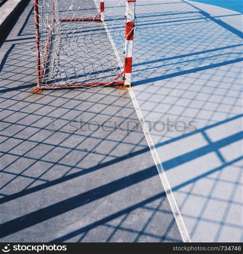 soccer goal and rope net in the field in the street