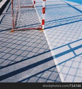 soccer goal and rope net in the field in the street