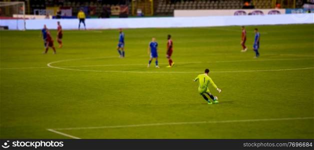 Soccer goalkeeper kicks out the ball during the match at stadium
