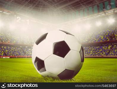 soccer or football ball on stadium, warm colors toned