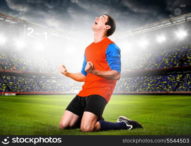 soccer or football player is celebrating goal on stadium