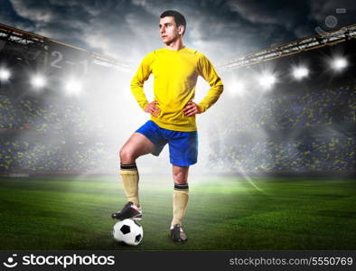 soccer or football player is standing on stadium. soccer player