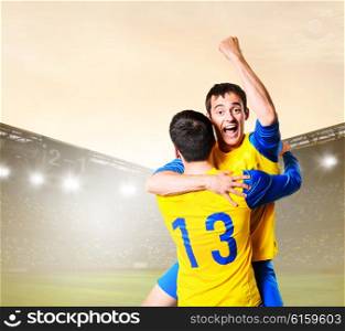 soccer or football players are celebrating goal on stadium. players celebrating goal