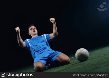 soccer player doing kick with ball on football stadium field isolated on black background