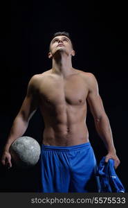 soccer player doing kick with ball on football stadium field isolated on black background