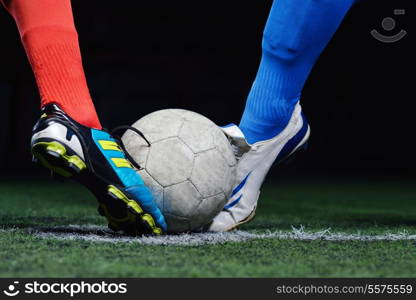 soccer player doing kick with ball on football stadium field isolated on black background