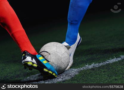 soccer player doing kick with ball on football stadium field isolated on black background